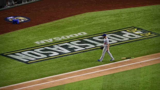 Oct 15, 2020; Arlington, Texas, USA; Los Angeles Dodgers starting pitcher Clayton Kershaw (22) walks off the field during the first inning against the Atlanta Braves in game four of the 2020 NLCS at Globe Life Field. Mandatory Credit: Jerome Miron-USA TODAY Sports